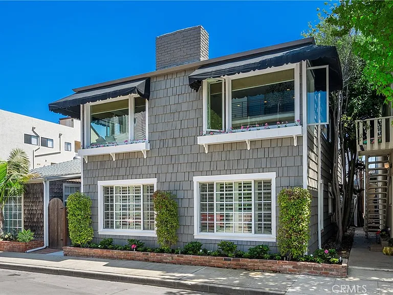 Two-story gray house with white-trimmed windows
