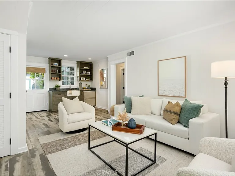 living room with white sofa, beige armchair, and a modern coffee table